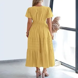 Back view detail of a yellow tiered maxi dress with puff sleeves and pleated fabric