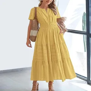 Detail view of a yellow V-neck tiered maxi dress with pleated puff sleeves and texture