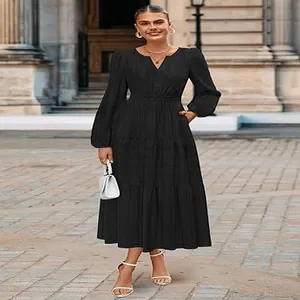 Close-up detail view of the elegant black V-neck tiered midi dress with stylish puff sleeves