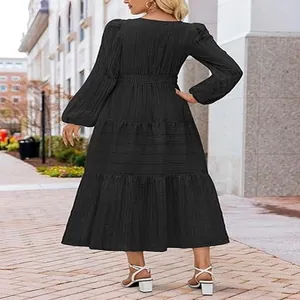 Back view of a black tiered maxi dress featuring puff sleeves and a cinched waistline