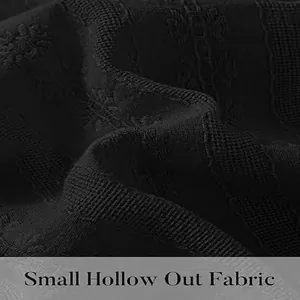 Detailed macro shot of black hollow-out fabric with delicate embroidery