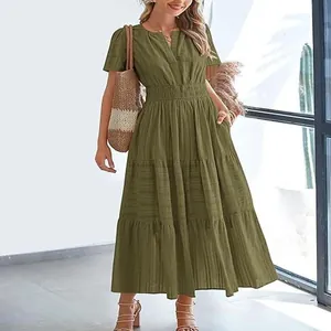 Close-up detail of olive green tiered maxi dress showing V-neck and elasticated waist