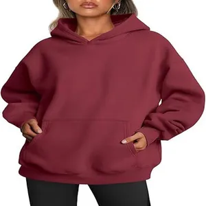 Detailed view of women's oversized maroon hooded sweatshirt with pocket