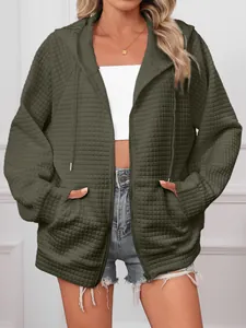 Close-up of olive green waffle knit hoodie with zipper and drawstring detail.
