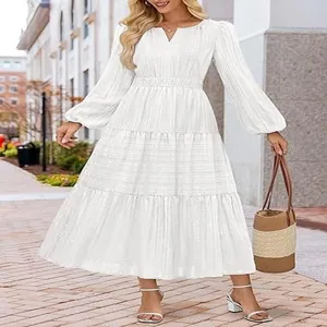 Elegant white tiered maxi dress featuring bubble sleeves and a cinched waist design