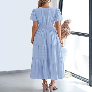 Back view of a light blue layered midi dress with puff sleeves and pleated waist.