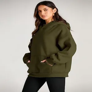 Profile view of an olive green oversized hoodie featuring a functional kangaroo pocket