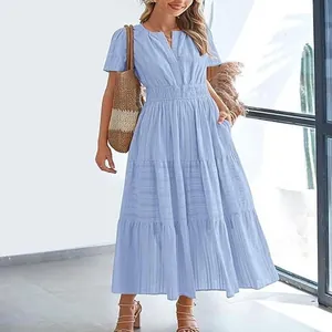 Detail of light blue V-neck tiered maxi dress with bubble sleeves and smocked waist.