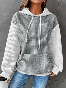 Detail view of women's color-block waffle knit hoodie with kangaroo pocket