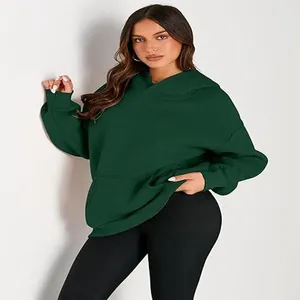 Detailed shot of dark green oversized women's hoodie with a hood and front pocket.