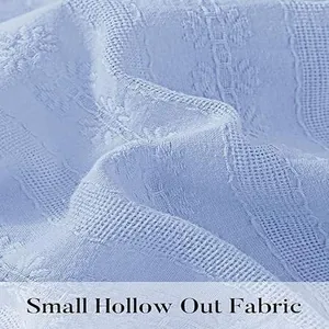 Macro view of blue fabric showing the intricate small hollow out pattern detail