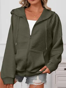Close-up detail of women's olive green waffle knit hooded zip-up jacket texture.