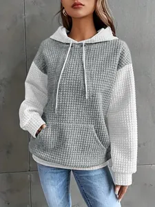 Detail view of the grey and white quilted texture hoodie with kangaroo pocket