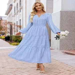 Model wearing a light blue V-neck tiered maxi dress with bubble sleeves in outdoor setting