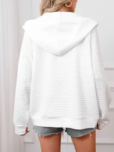 Back view of a white waffle knit hoodie showing its textured fabric and casual fit