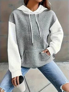 Detail of women's waffle textured color block pullover hoodie with drawstring design