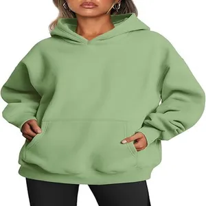 Detail view of a cozy oversized sage green hoodie for women with a functional kangaroo pocket