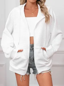 Detailed view of women's white waffle knit hooded zip-up sweatshirt texture