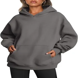 Front view detail of a women's oversized grey hooded sweatshirt with pocket