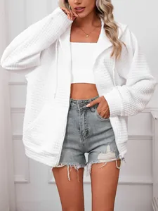 Macro detail view of a white waffle knit hooded zip-up sweatshirt with adjustable drawstring