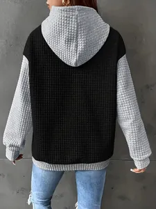 Back view detail of a plus size color-block waffle texture hoodie for women in black and grey