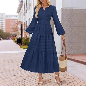 Elegant navy blue V-neck tiered maxi dress with long puff sleeves and smocked waist detail