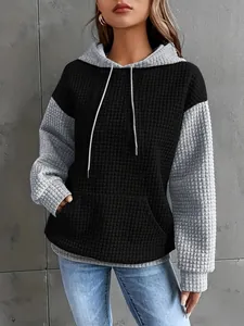 Detail of fashionable color-block waffle knit hoodie for women with textured fabric