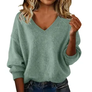 Detail view of a soft sage green V-neck knit sweater featuring a loose and comfortable fit.