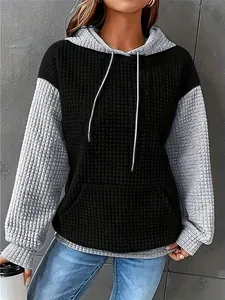 Close-up detail of women's stylish color-block waffle texture drawstring hoodie outfit