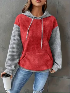 Close-up view of waffle textured color-block hooded sweatshirt with pouch pocket