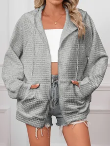 Detail view of grey waffle knit hooded zip-up jacket for women in casual style
