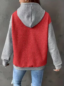 Back view of women's color-block hoodie featuring textured waffle knit fabric