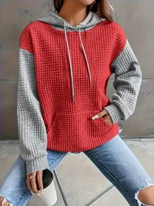 Close-up detail of women's red and grey color-block waffle texture pullover hoodie