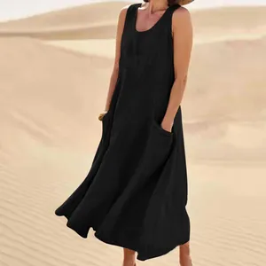Elegant sleeveless black cotton linen maxi dress with pockets shown in a desert landscape