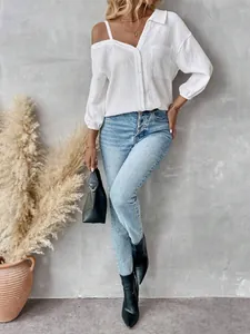 Macro view of white off-shoulder blouse featuring textured fabric and button-down front
