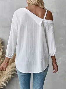 Close-up of white textured off-shoulder blouse showing back design and crinkled fabric.