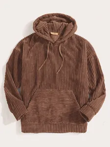 Detailed view of brown corduroy hoodie texture with ribbed cuffs and kangaroo pocket
