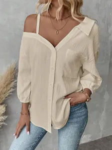 Detailed view of the crinkle texture and off-shoulder design on this cream blouse