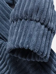Detailed view of the soft blue corduroy fabric texture and ribbed cuff of a men's hoodie.