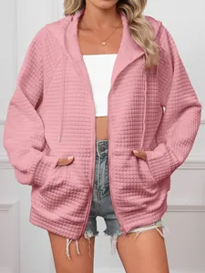 Detailed view of casual women's pink waffle knit zip-up hoodie featuring oversized fit