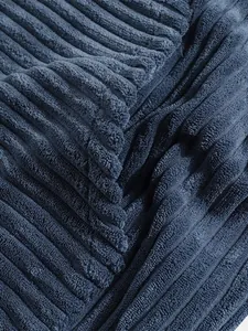 Close-up detail showing the soft ribbed texture of navy blue corduroy fabric