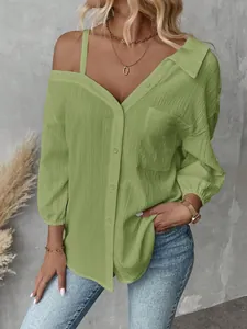 Detail of green crinkle texture shirt with off-shoulder and button-down design