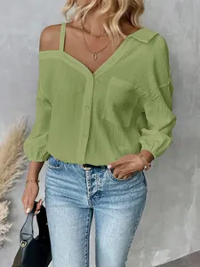 Detailed view of a green textured off-shoulder shirt with lapel and button-up front