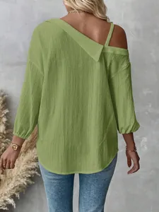 Rear view of a textured green off-the-shoulder blouse with stylish 3/4 sleeves