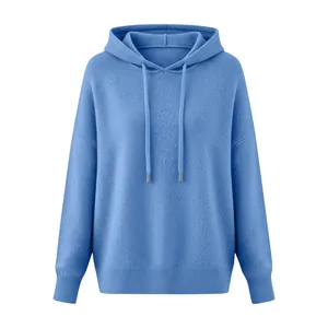 Close-up view of a soft blue knitted drawstring hoodie with ribbed cuffs and hem.