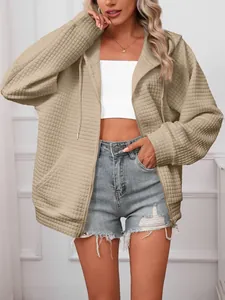 Detailed texture of women's khaki waffle knit zip-up hoodie with drawstring