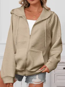 Detail view of the khaki waffle knit texture on this hooded zip-up jacket for women.