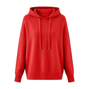 Detailed macro view of vibrant red brushed fabric on hooded knitted sweater for women