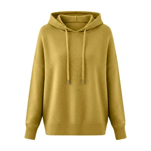 Detail shot of a ginger knit hoodie featuring a soft brushed texture and drawstrings.