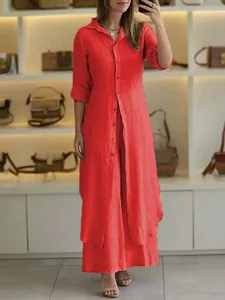 Mirror selfie of a woman wearing an elegant red cotton linen shirt and wide-leg pants set